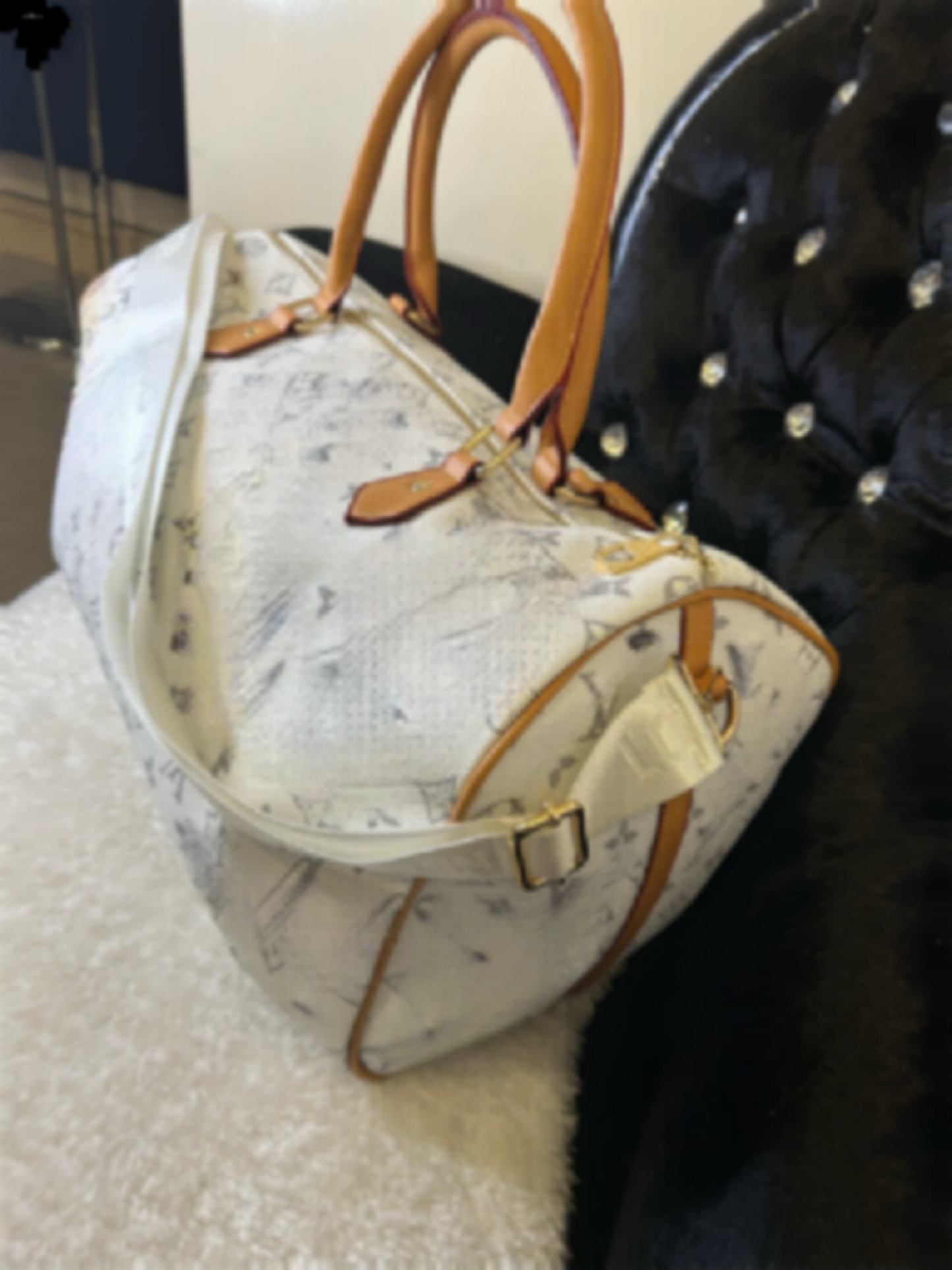 white holdall with inspired print prints on the whole of the bag, with long shoulder strap