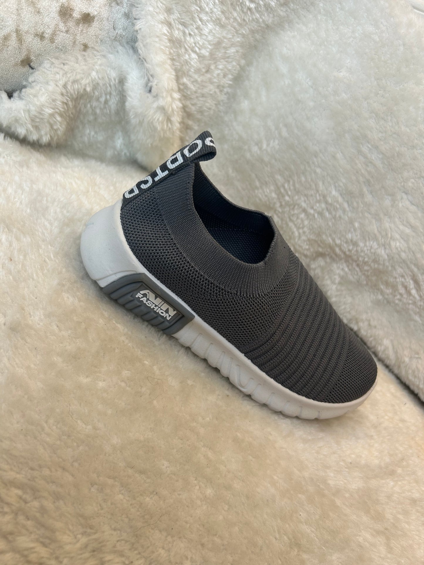Children’s grey slip on trainers with white soles