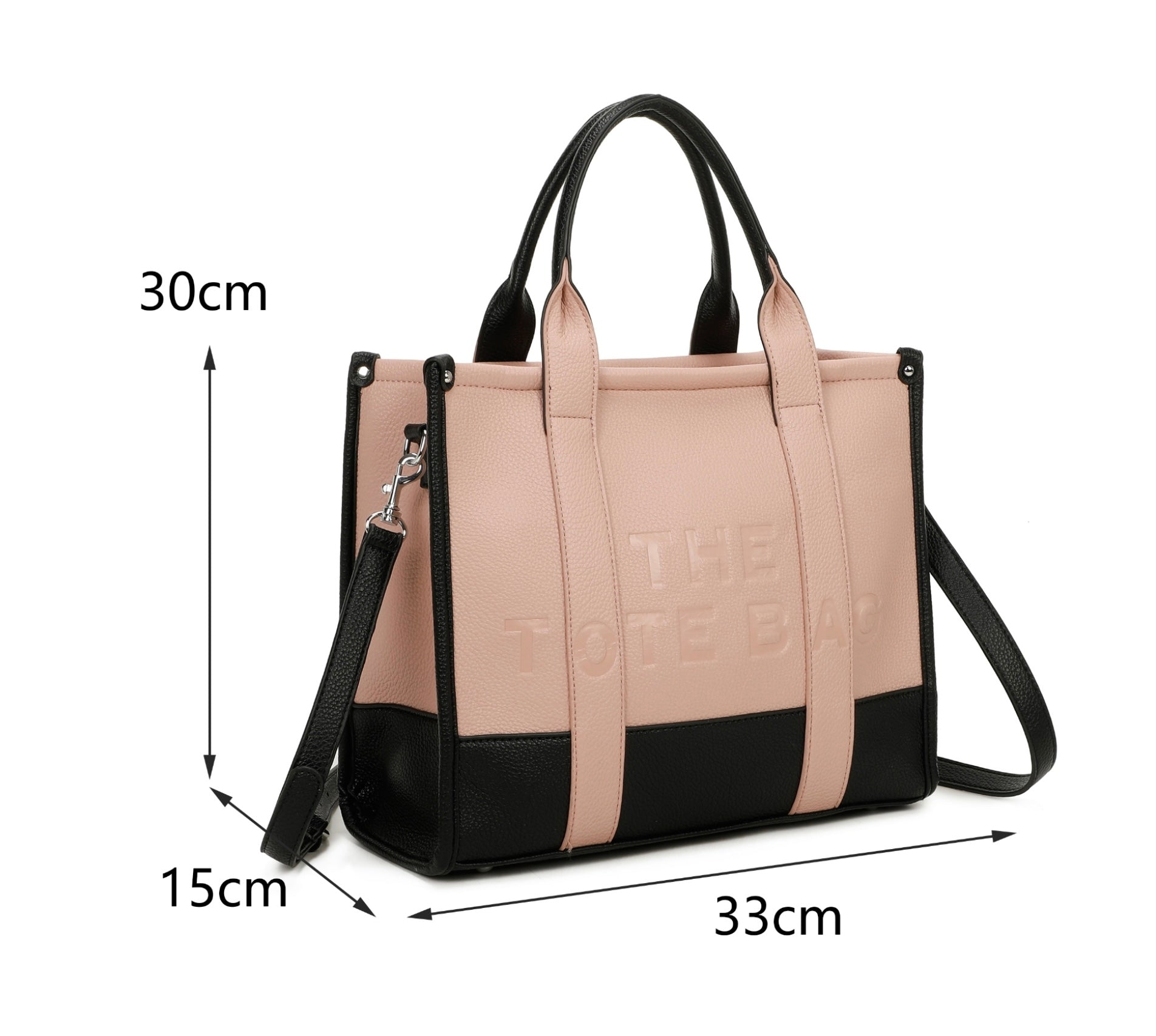 Pink and black handbag with 'The tote bag ‘ embossed into the front with silver hard wear