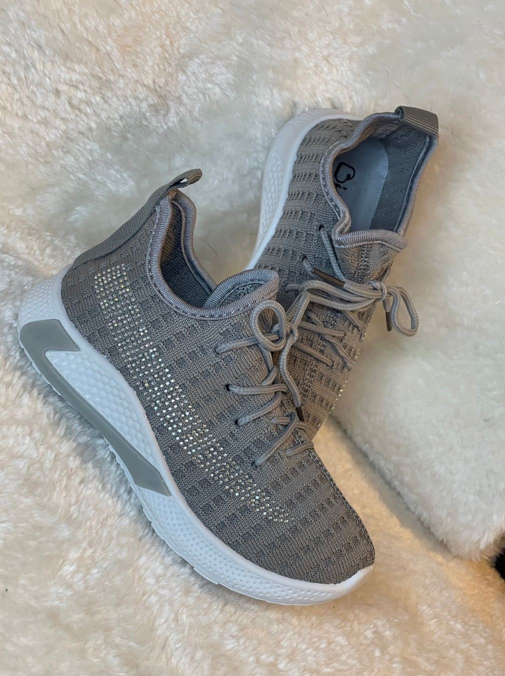grey girls trainers with a small crystal detail on the side.