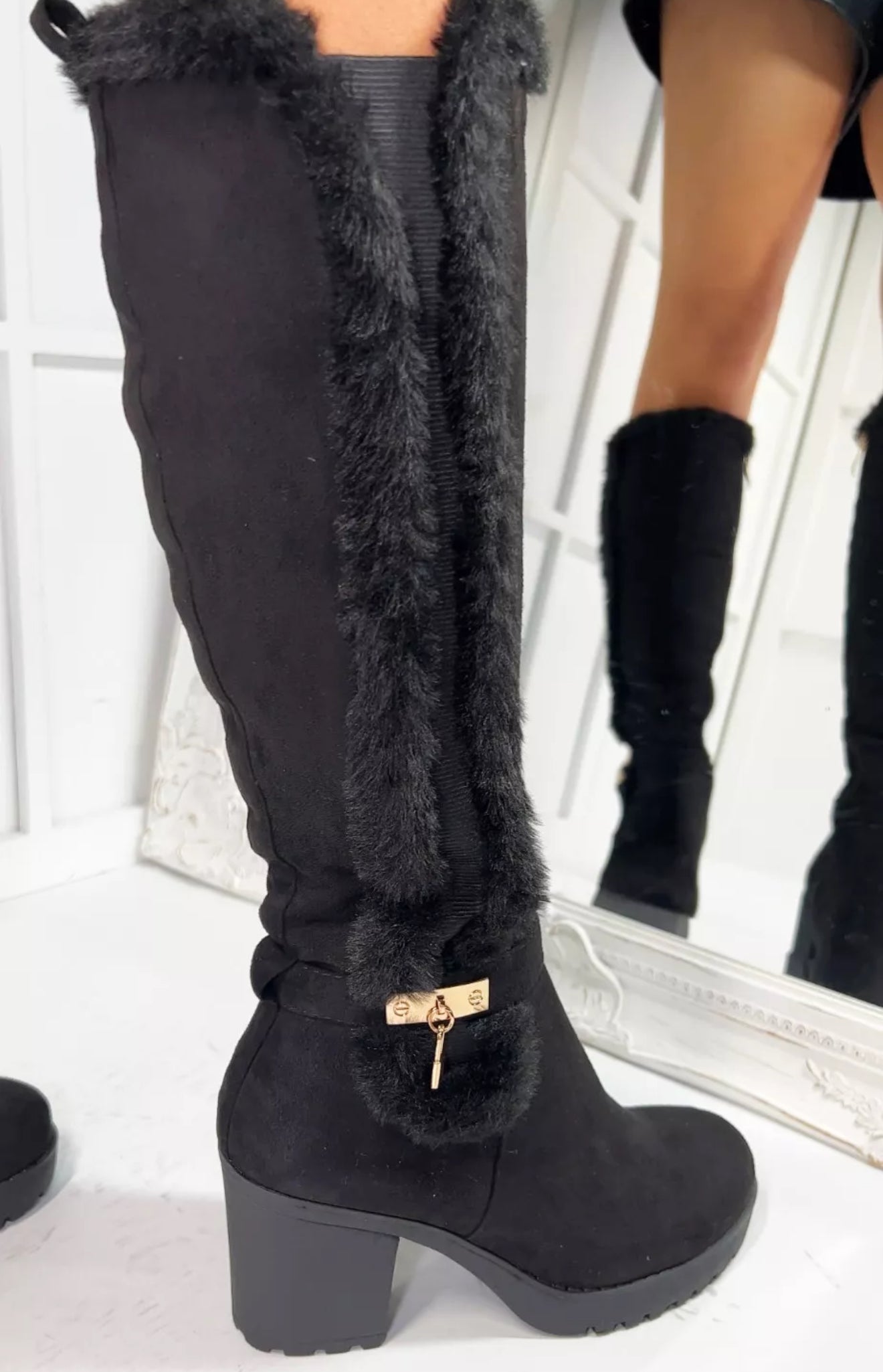 Black knee-high boots with a block heel and soft faux-fur lining