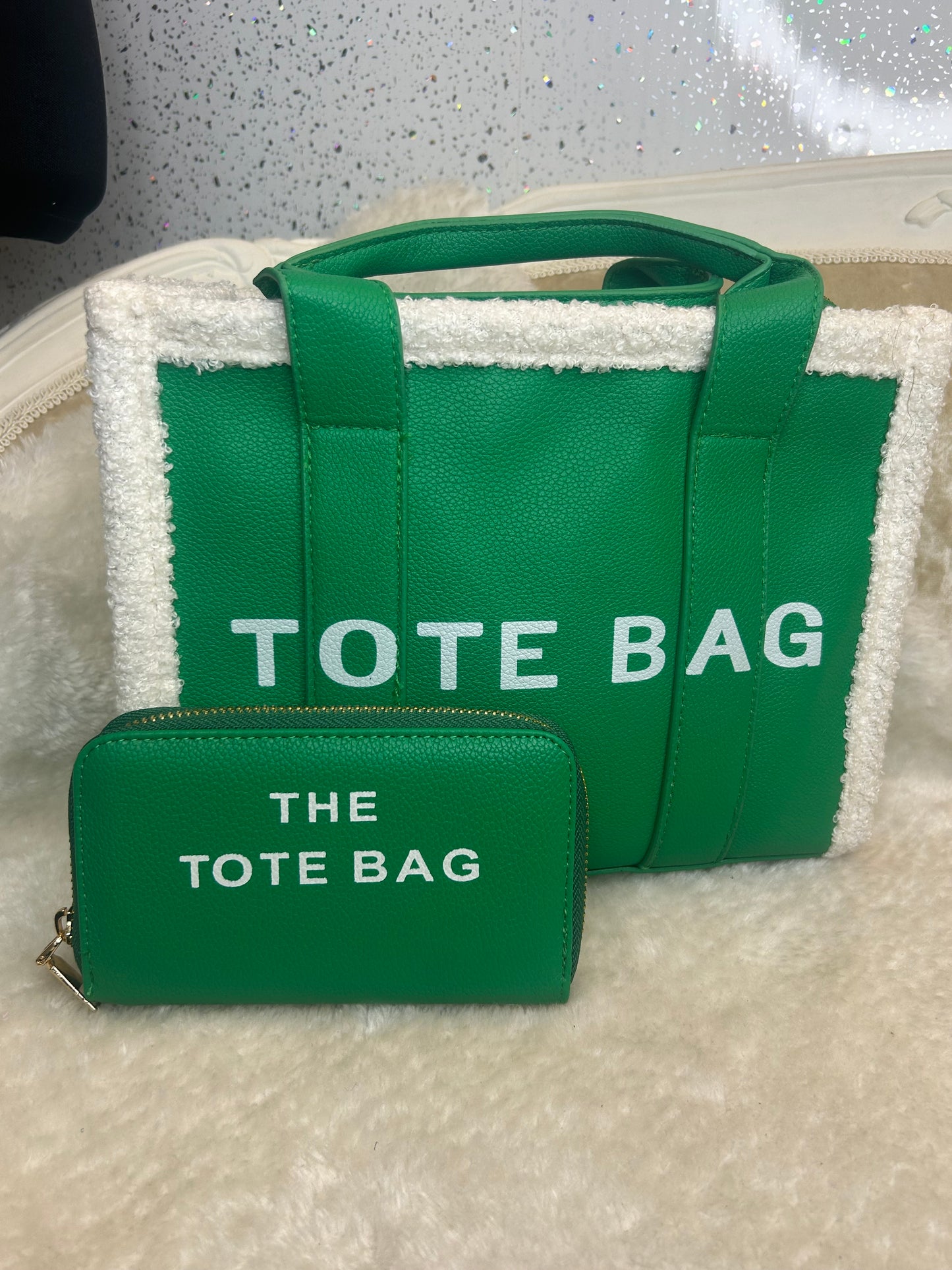 Green fuzzy tote bags with 'TOTE BAG' text and matching purse