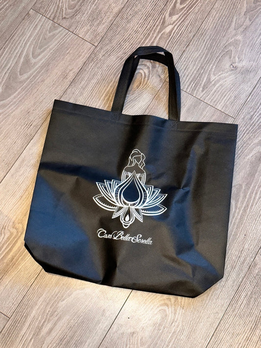 A black shopping bag with a white floral pattern and text that reads 'Casa Bella Sorella'