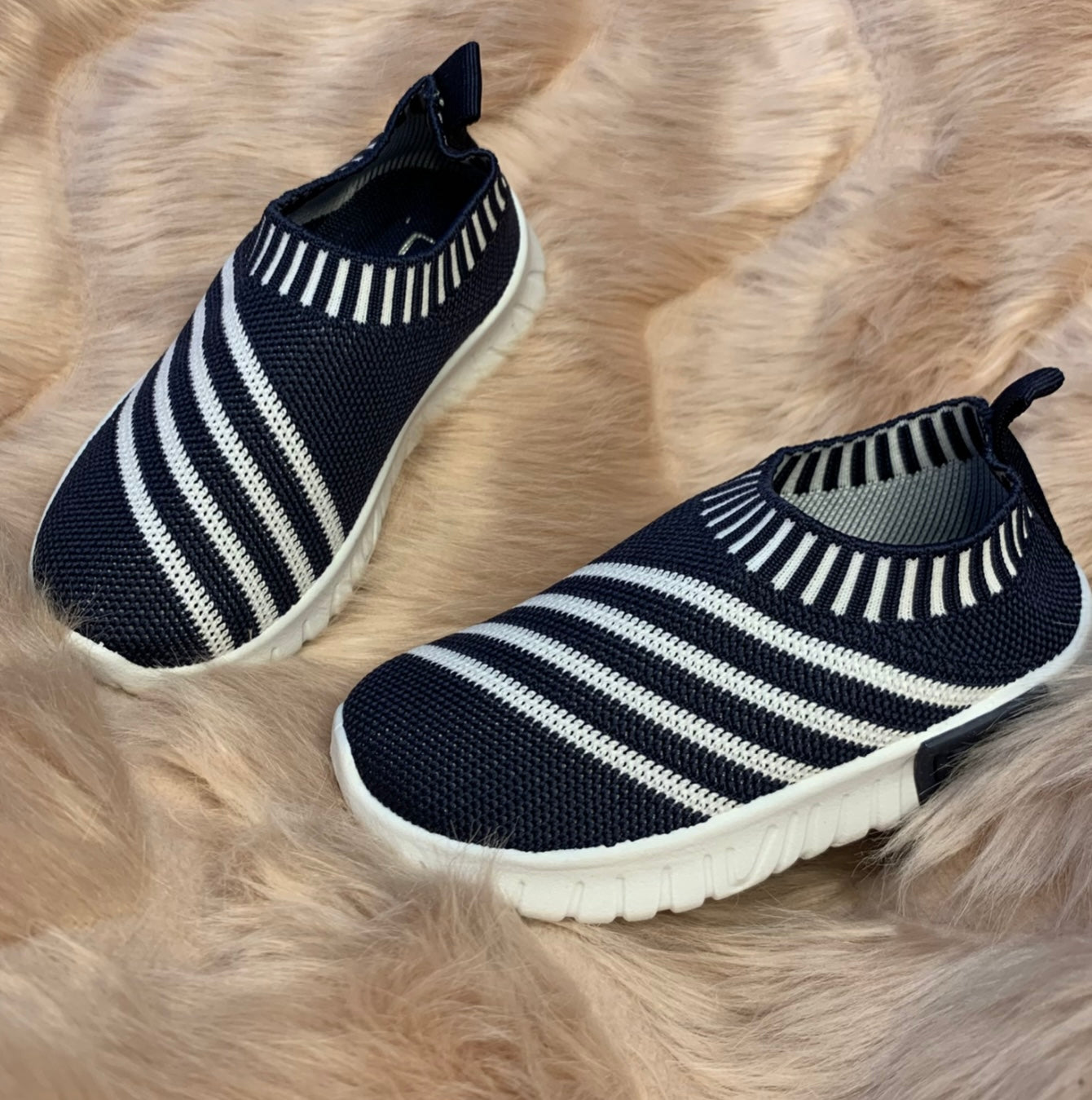 A pair of navy & white stripe kids' slip-on athletic shoes