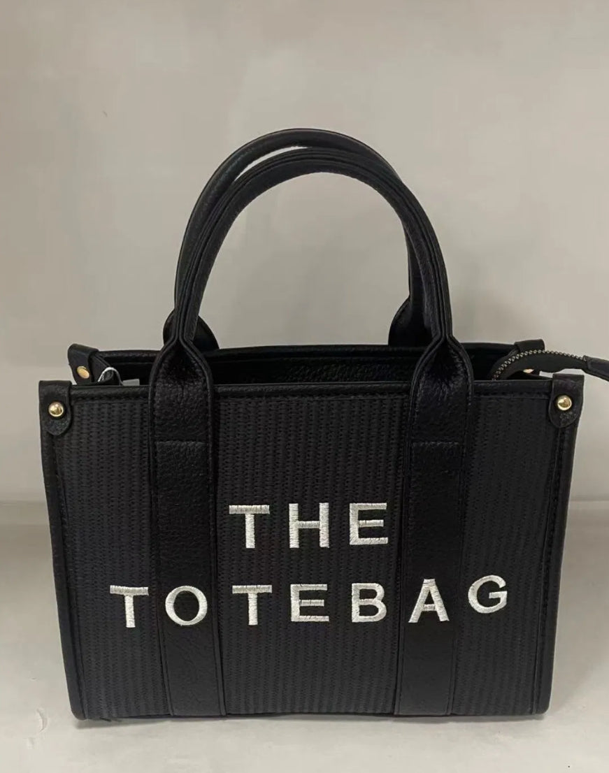 Black tote bag with 'THE TOTEBAG' text