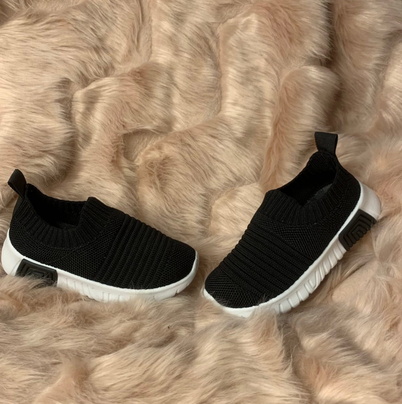 A pair of black kids' slip-on athletic shoes