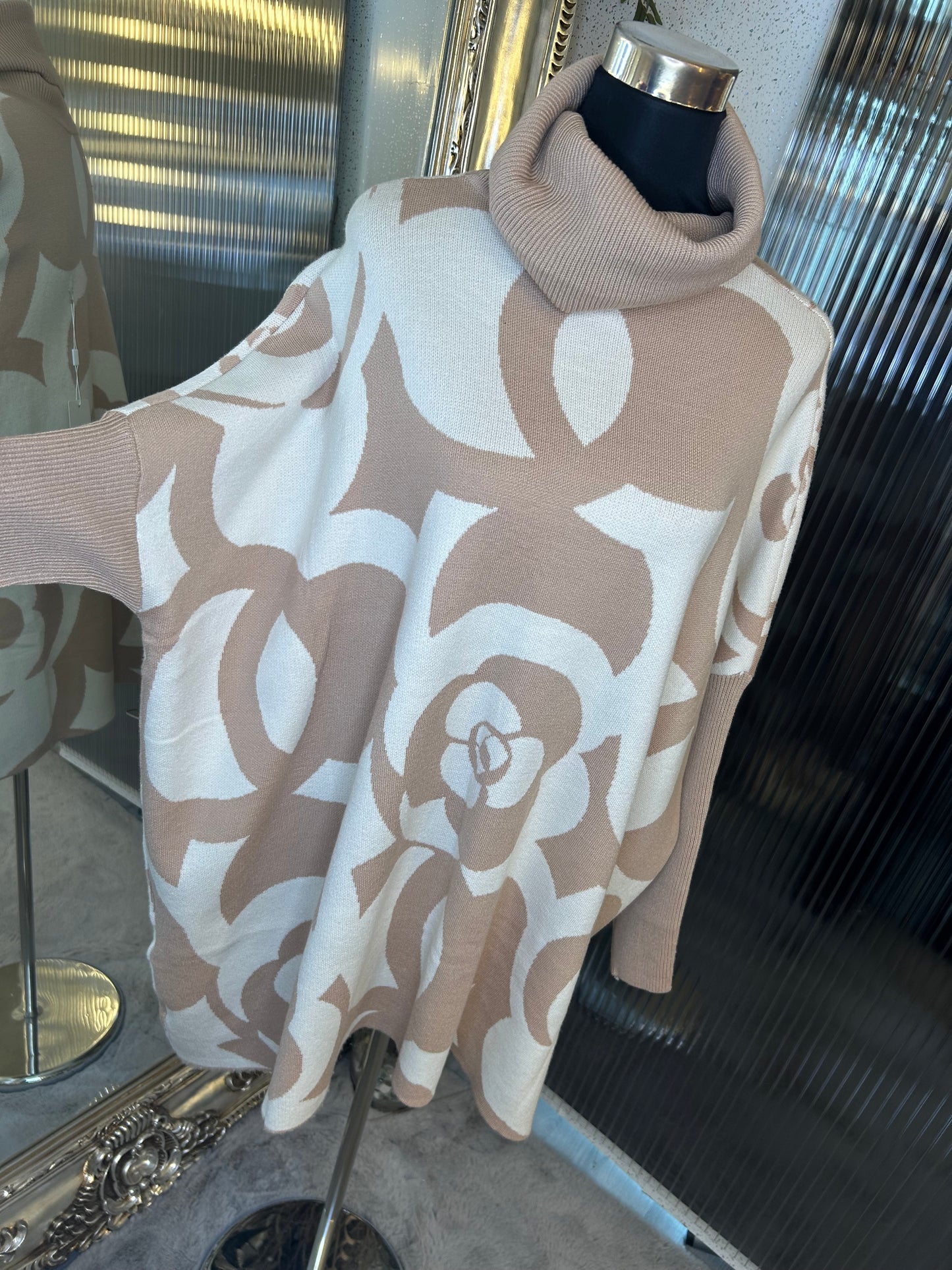 A beige and white floral printed roll neck oversized jumper.