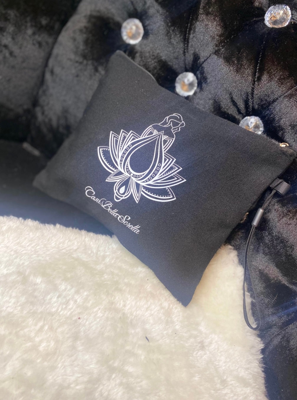 A black canvas mini insert bag with a white floral design and text