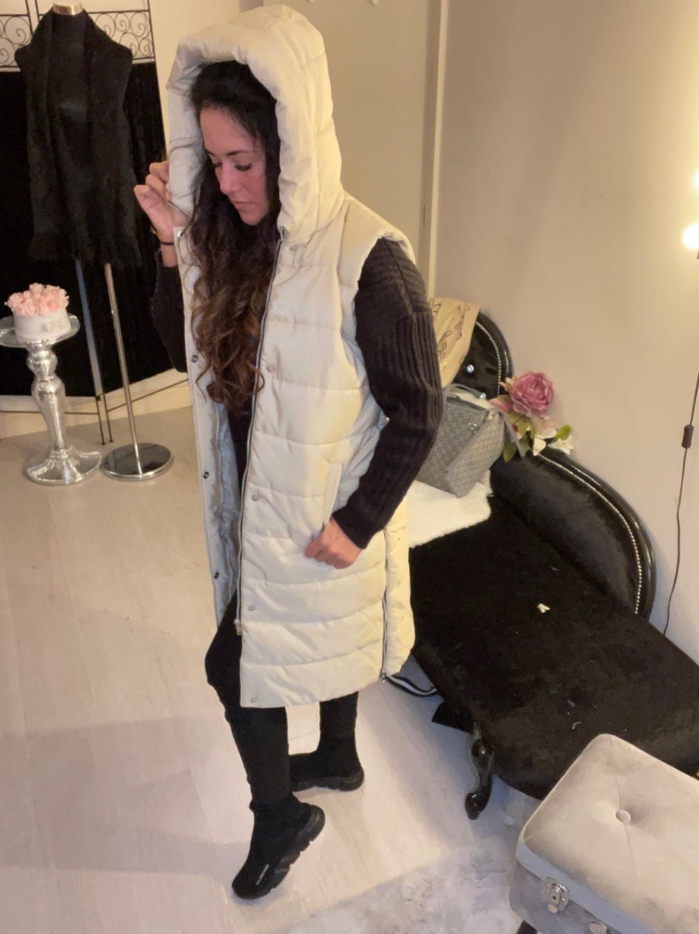 side of cream long line body warmer with side zips for walking and a hood
