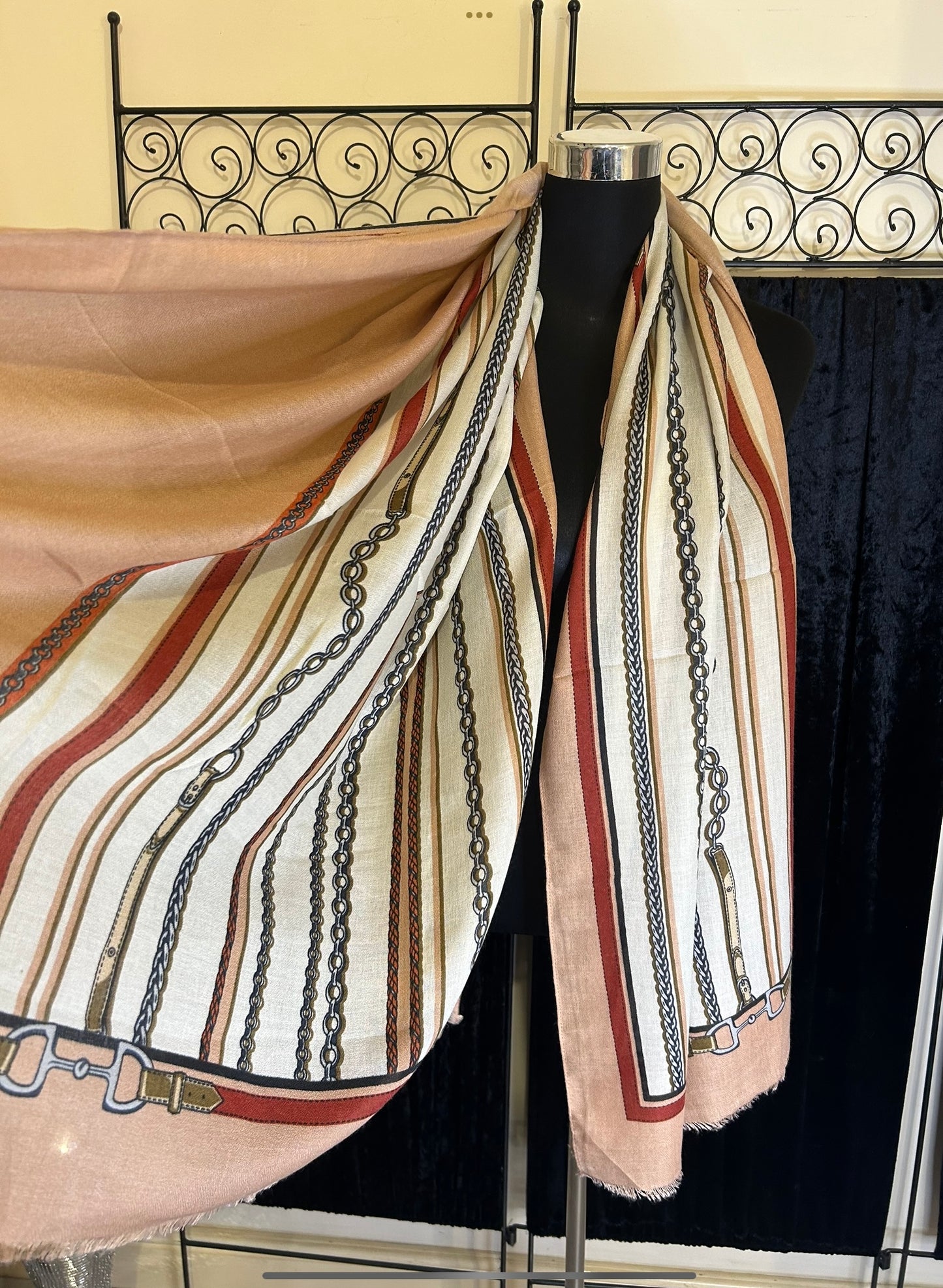 Colourful chain print scarf with stripes in cream, red, and peach tones, displayed on a mannequin.