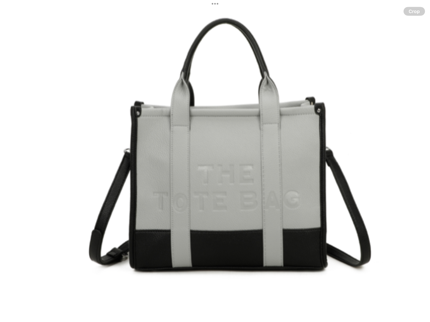 Grey and black handbag with 'The tote bag ‘ embossed into the front with silver hard wear