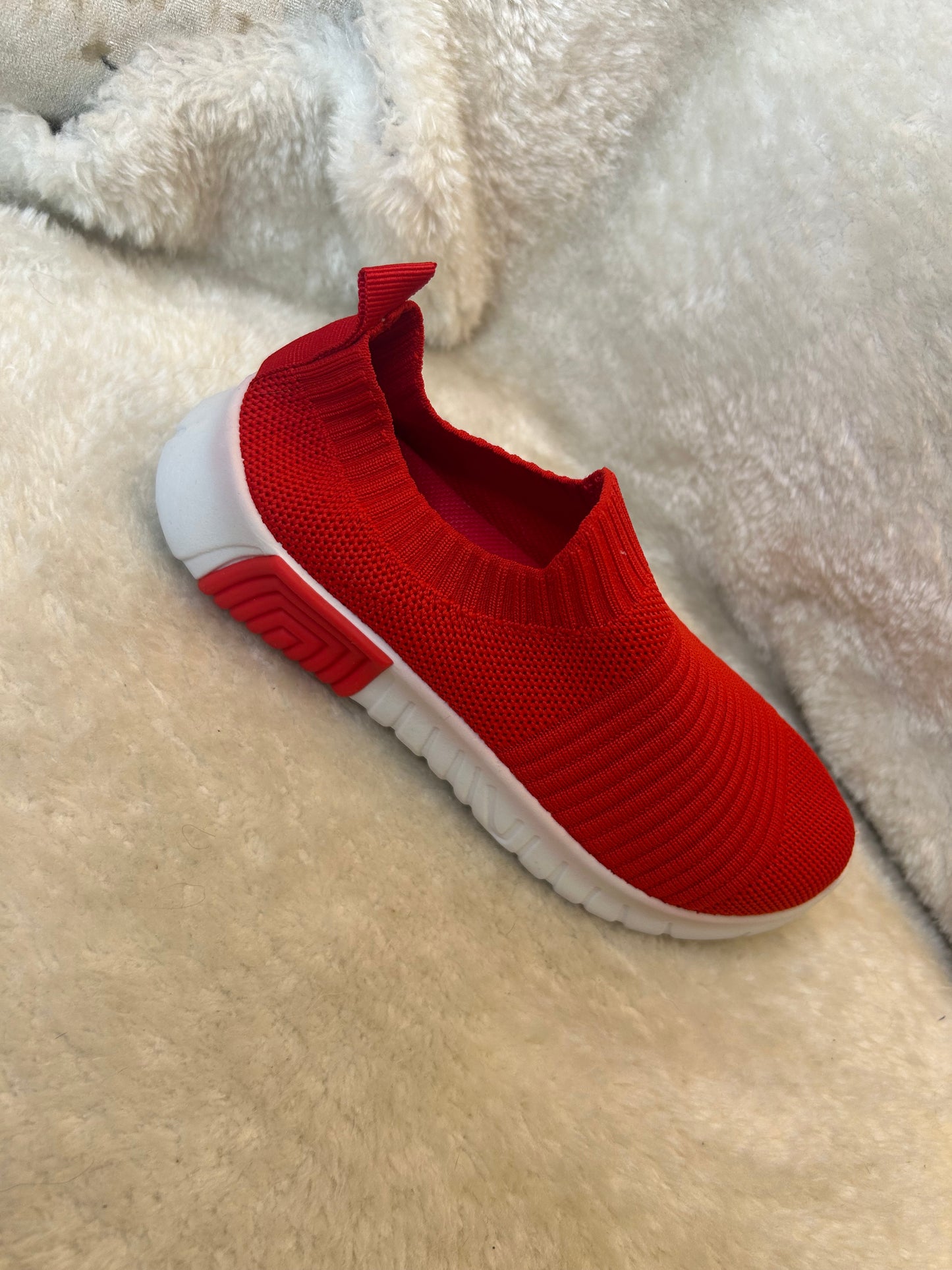 Children’s red slip on trainers with white soles