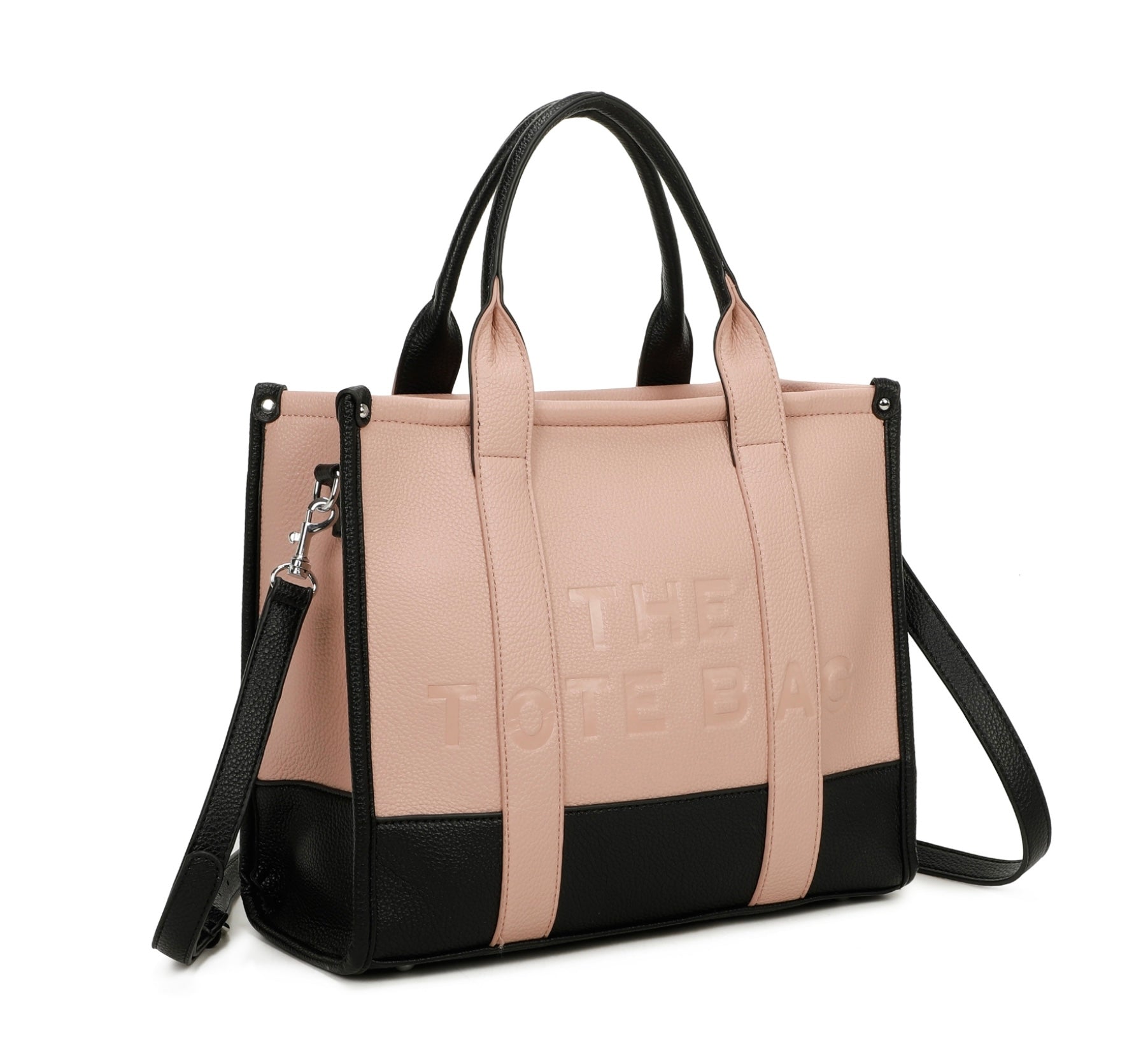 Pink and black handbag with 'The tote bag ‘ embossed into the front with silver hard wear