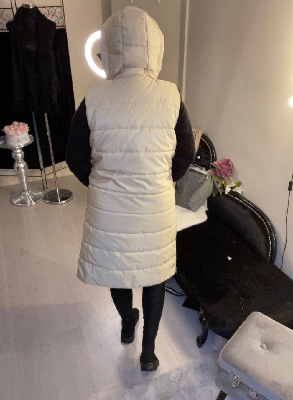 back of Cream long line body warmer with side zips for walking and a hood