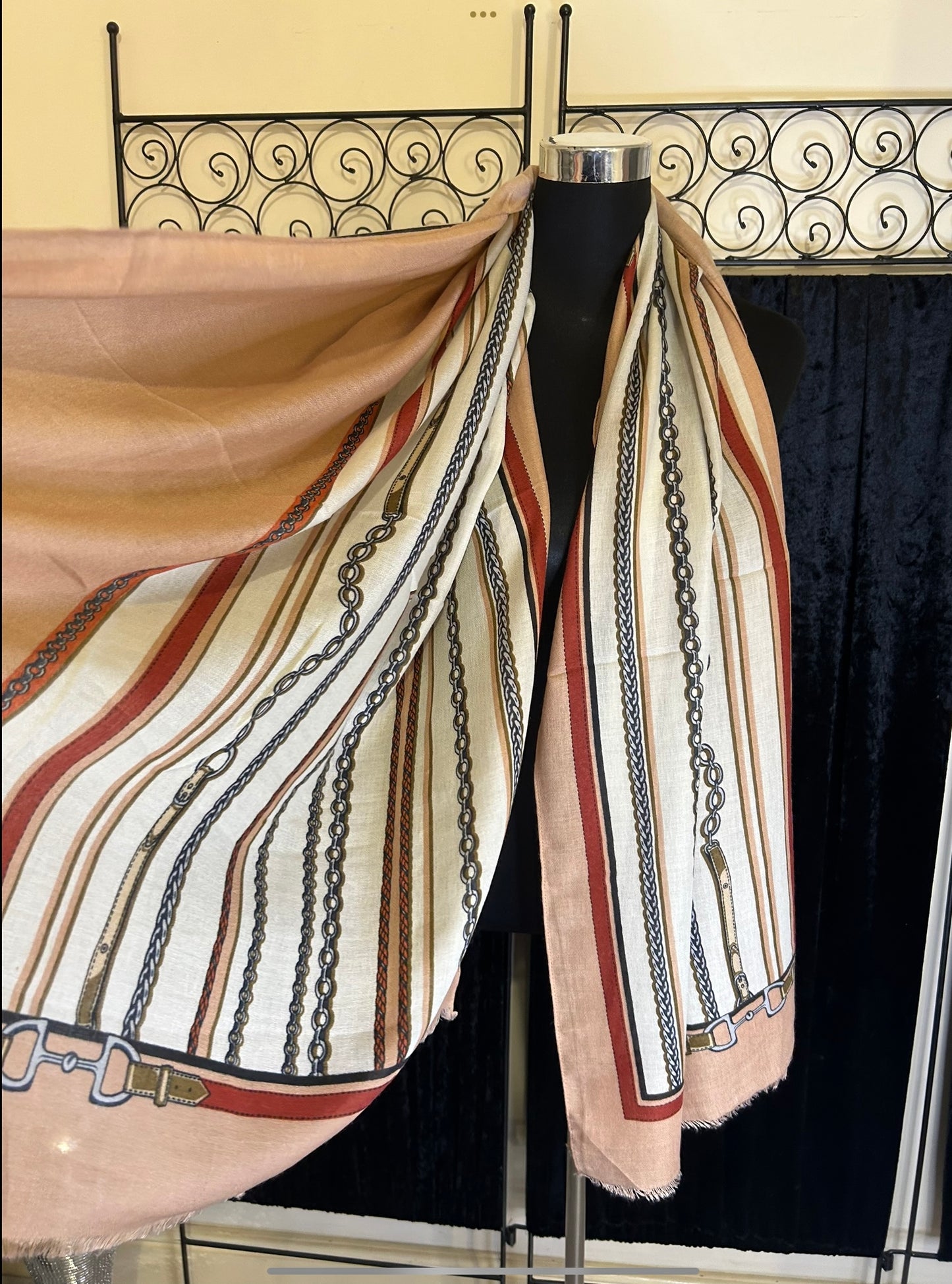 Colourful chain print scarf with stripes in cream, red, and peach tones, displayed on a mannequin.