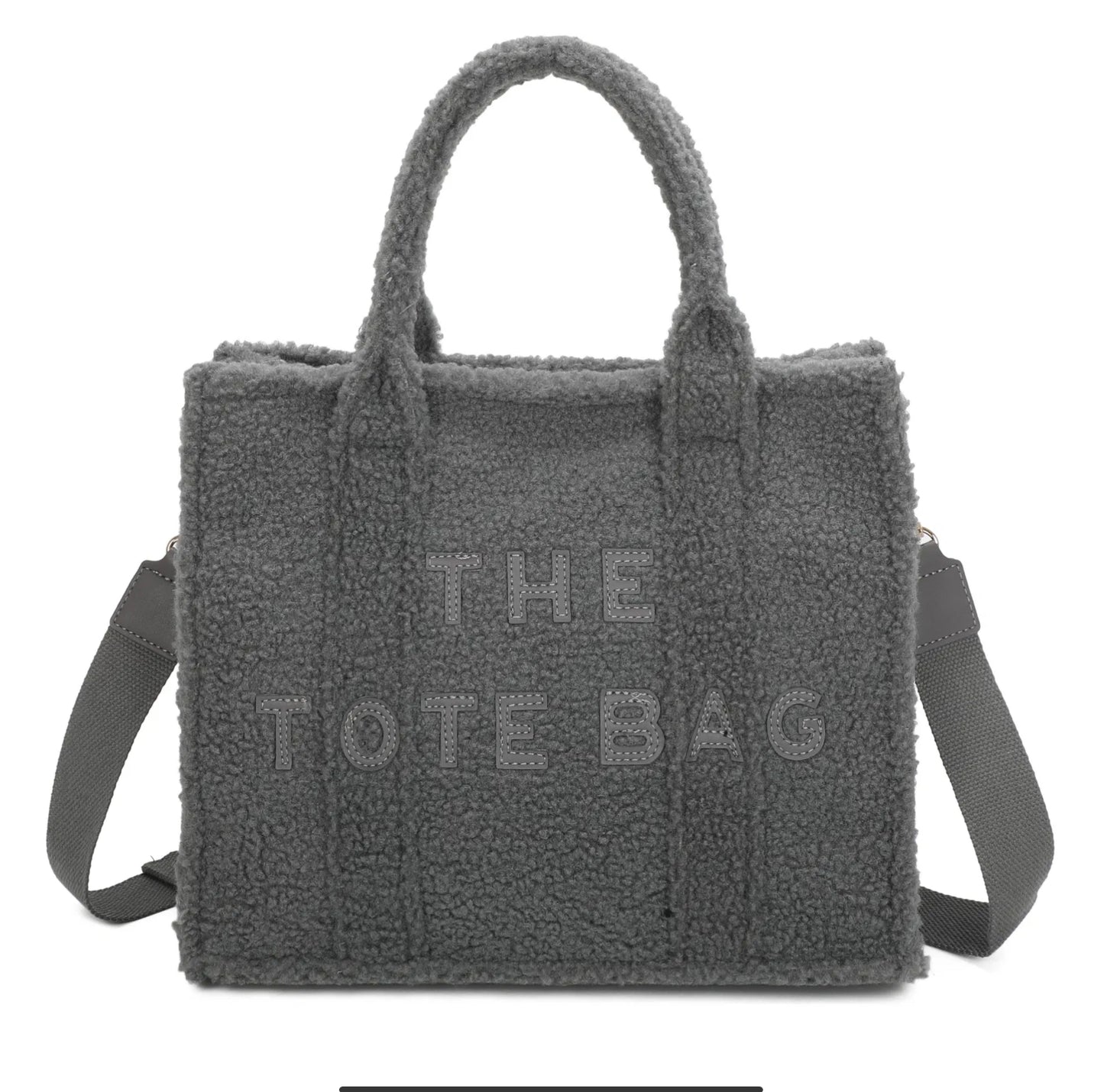 Fully woolly tote bag with embossed ‘the tote bag’ text on and a long adjustable strap in grey