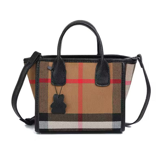 Small black outlined checked style bag with crossbody long strap
