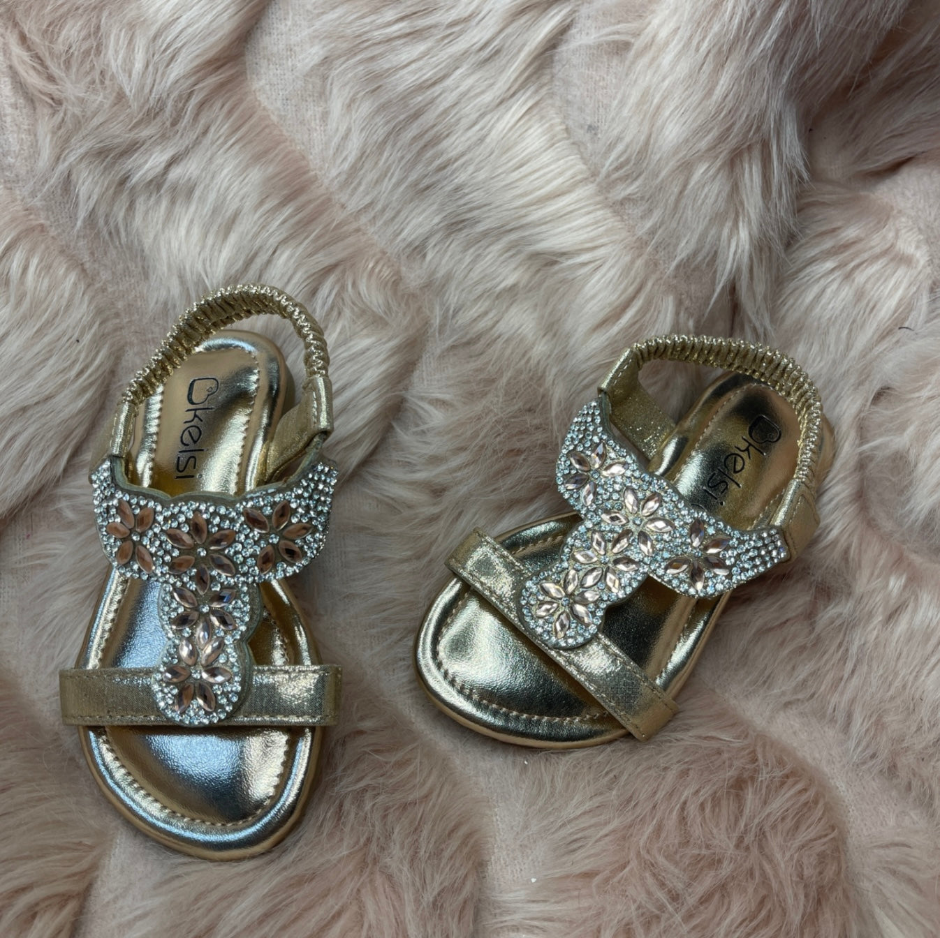 A pair of rose gold crystal embellished slip-on sandals