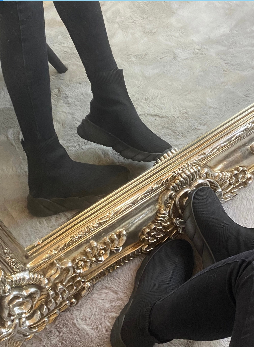 A pair of black sock-style slip on trainers