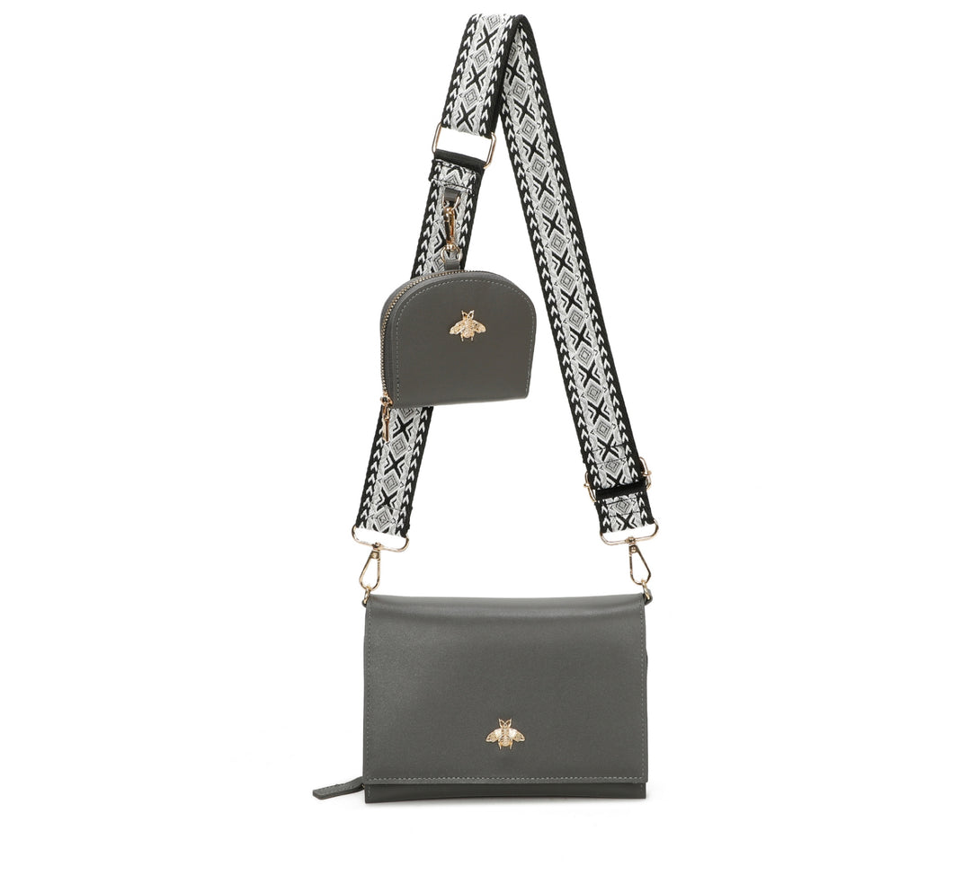Gray handbag with a patterned strap on a white background