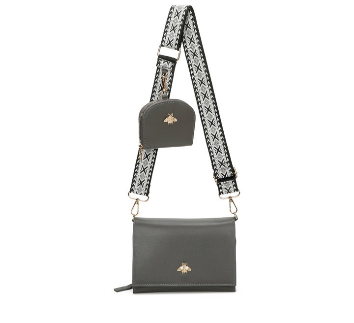 Gray handbag with a patterned strap on a white background