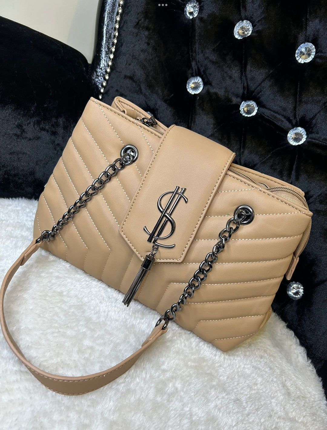 Beige quilted medium size handbag with metal hardware, chain straps and flap closure