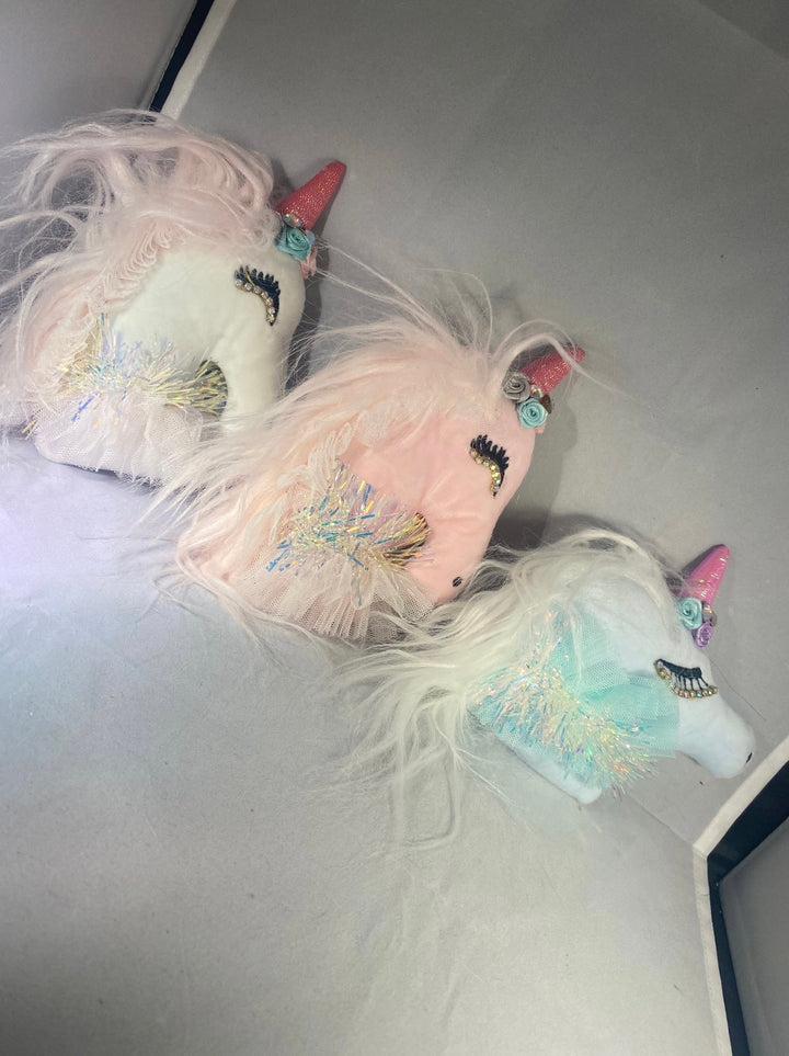 A set of three unicorn-themed key ring chains in pink, white, and blue colors, with glitter and decorative elements.