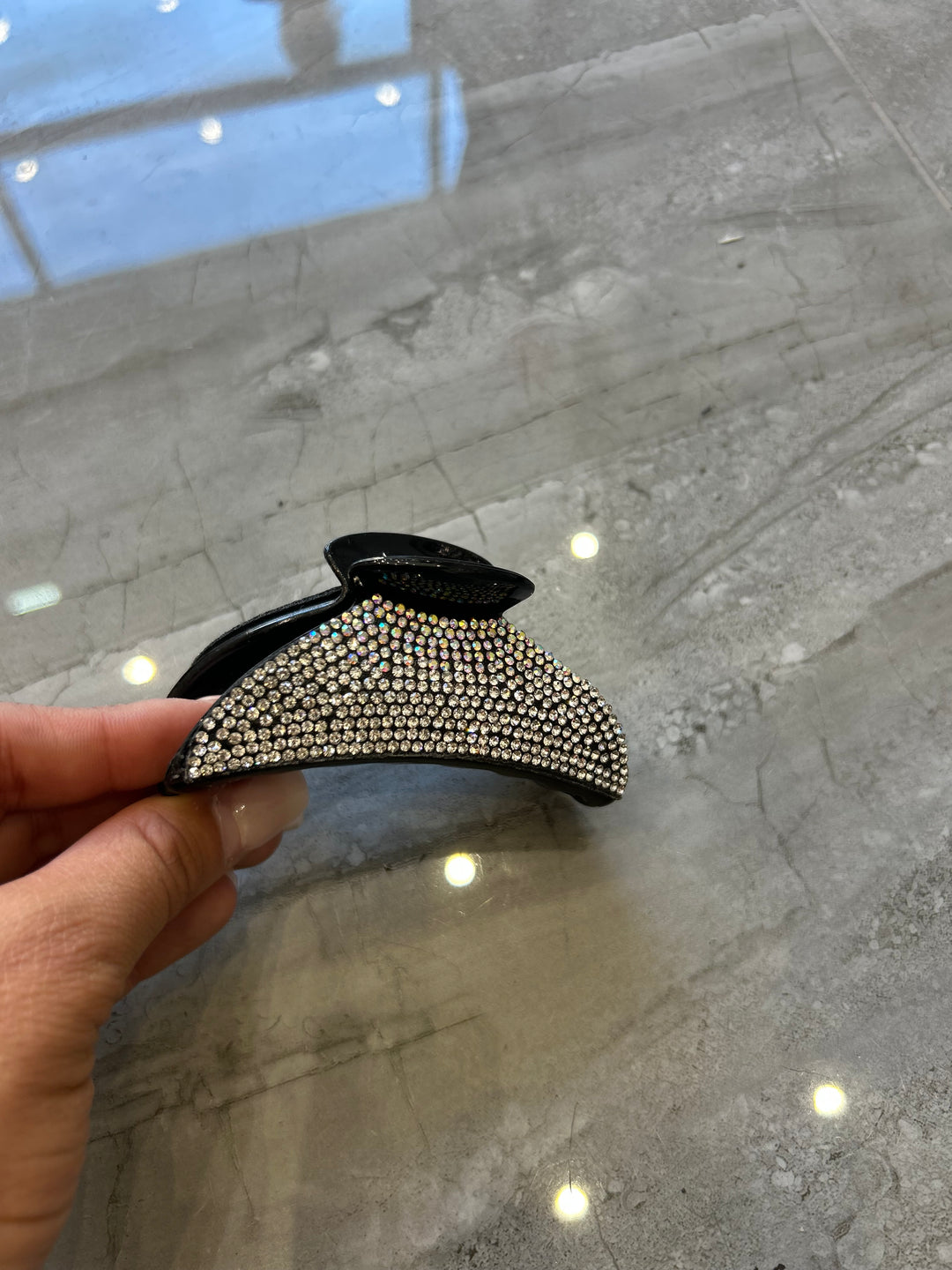 A black hair clip detailed with silver crystal rhinestones 