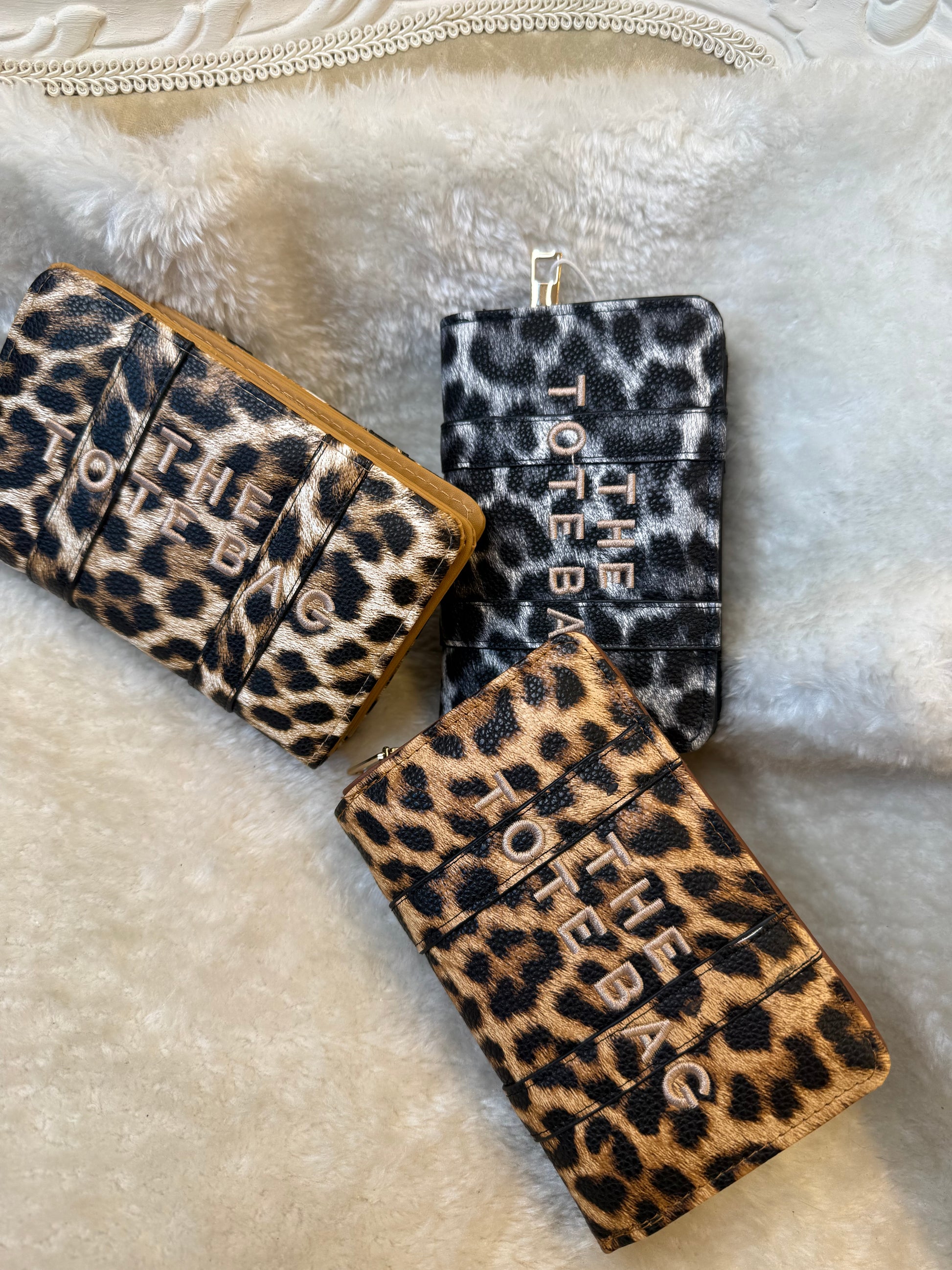 Leopard animal print card holders purses with embossed ‘The Tote Bag’ lettering and gold zip detail