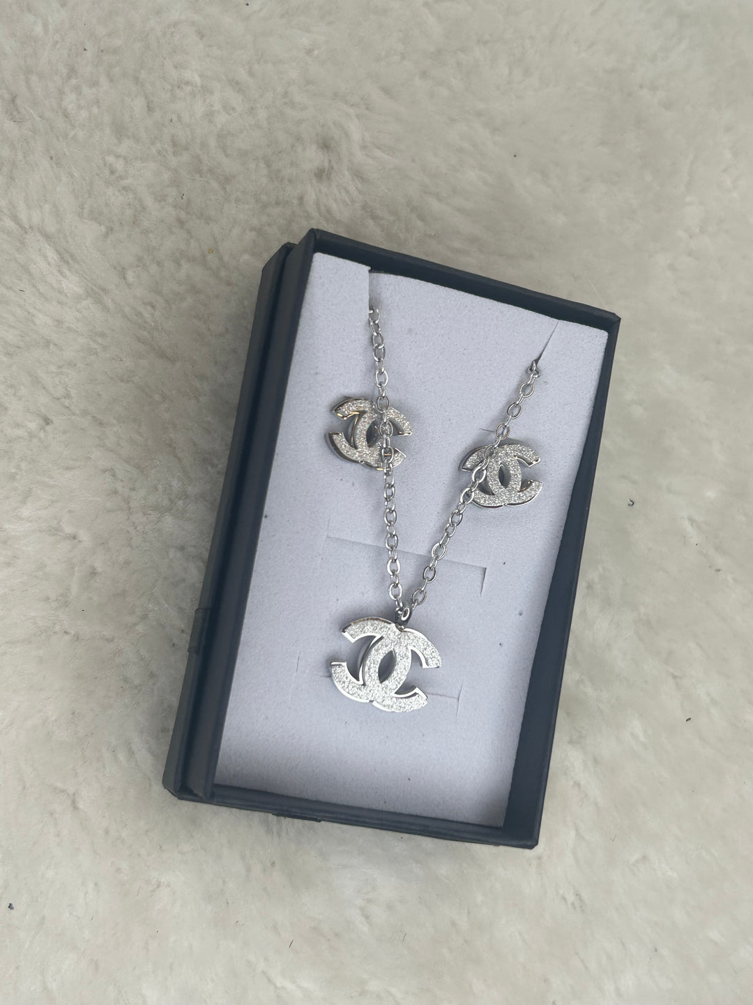 Silver matching necklace and earrings with sparkling crystal detailing