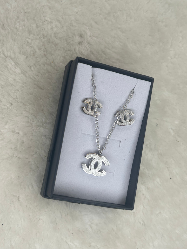 Silver matching necklace and earrings with sparkling crystal detailing