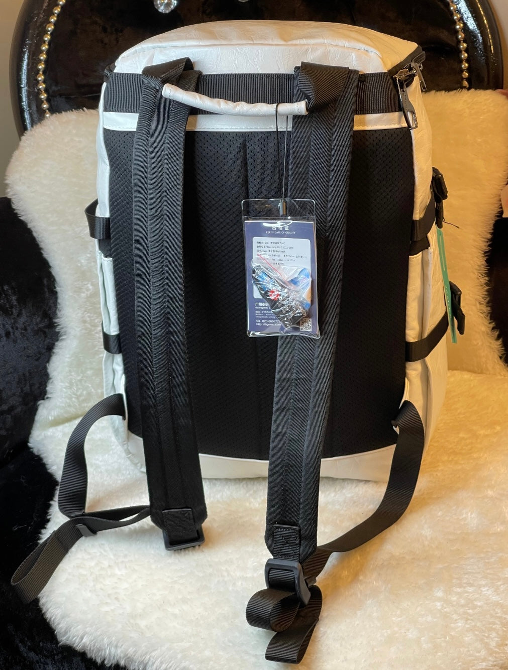 large black leather-look backpack with multiple zip compartments, adjustable straps and modern design, practical travel and work bag