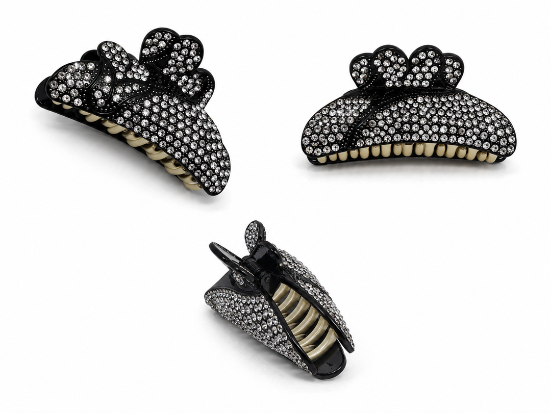 Black bow-shaped hair claw clip decorated with sparkling clear diamanté crystals
