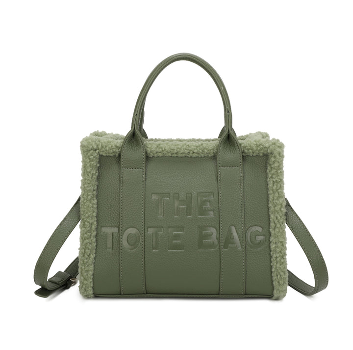Tote bags with fuzzy edge trim, embossed with ‘The Tote Bag’ on the front in green 