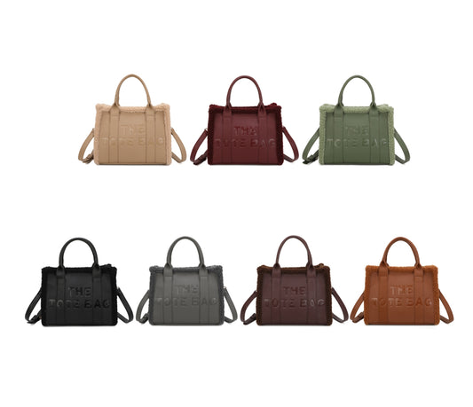 Tote bags with fuzzy edge trim, embossed with ‘The Tote Bag’ on the front