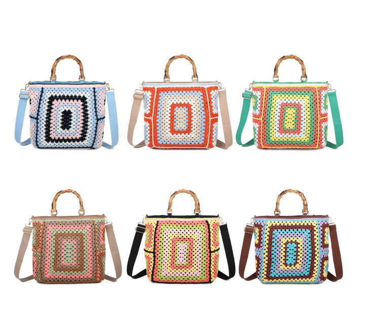 A collection of colorful crochet grab bags with bamboo handles and a top zip closure. They feature a knitted crochet pattern all over, gold tone metal hardware, and different colored straps.