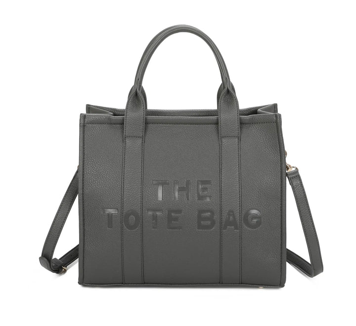 A dark grey tote bag with embossed ‘The Tote Bag’ text, structured design with top handles and detachable shoulder strap