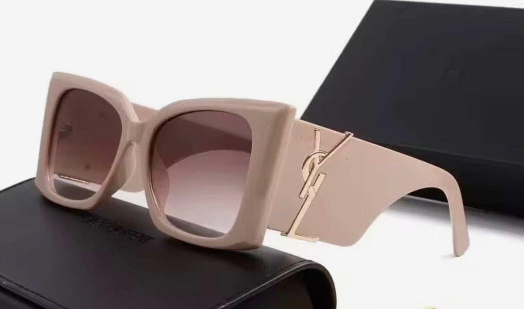 Beige chunky sunglasses with a gold logo 