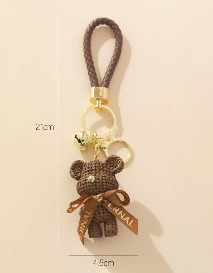     Brown teddy bear keyring with braided wrist strap and gold bell charm.