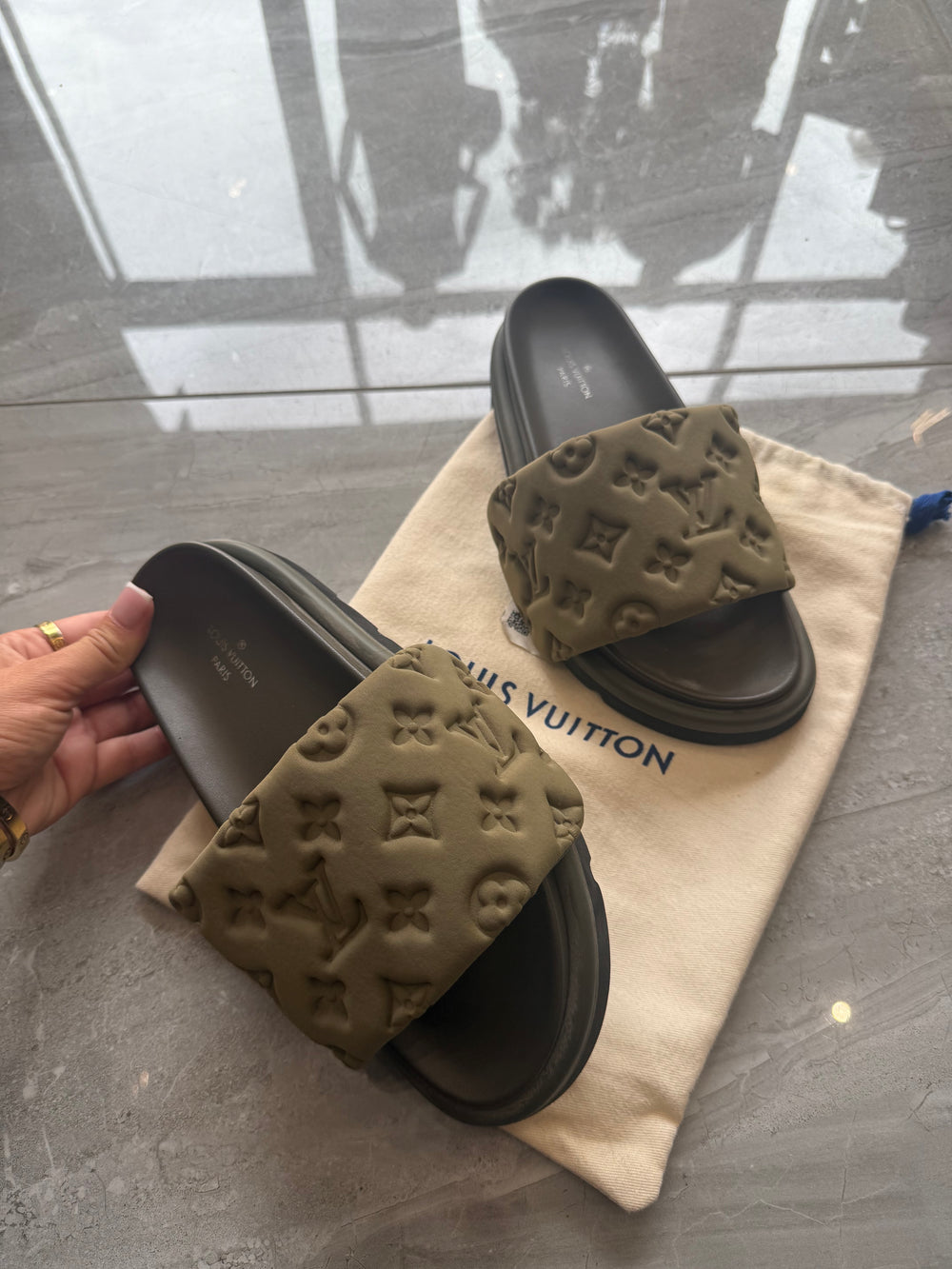 Khaki padded embossed platform sliders with cushioned footbed and chunky sole.