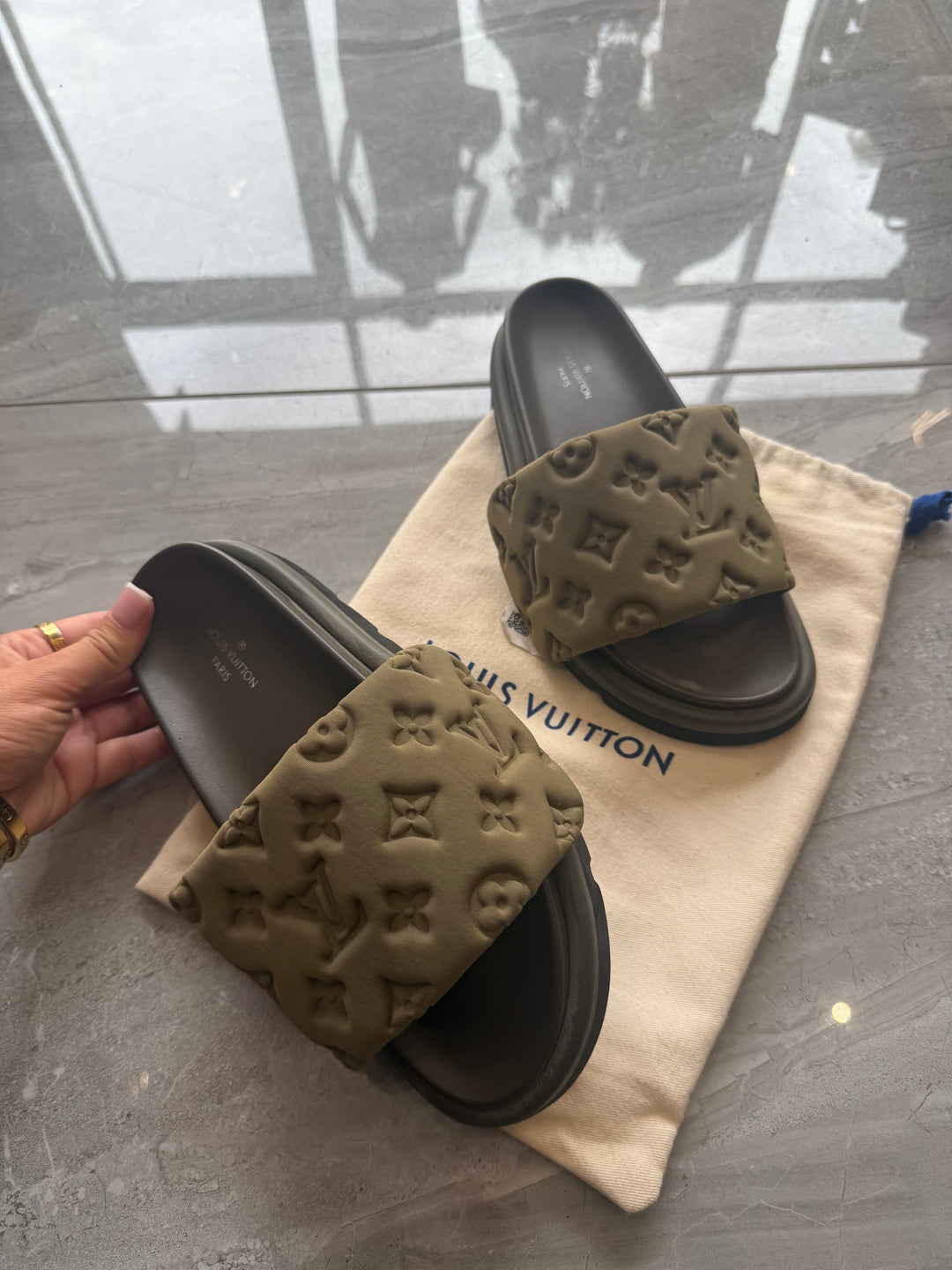 Khaki padded embossed platform sliders with cushioned footbed and chunky sole.