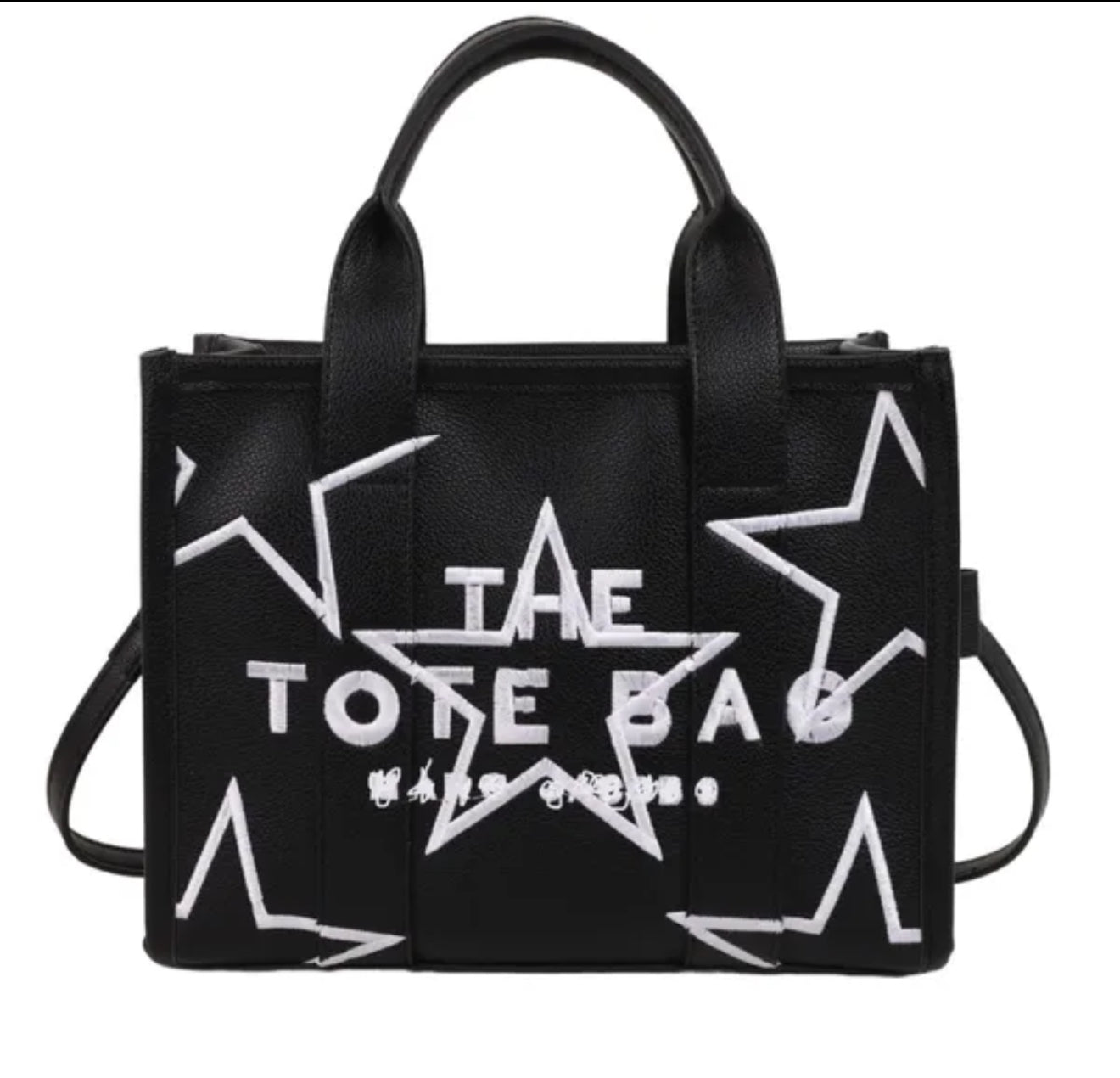 Black tote bag with white star designs and 'The Tote Bag' text on a white background