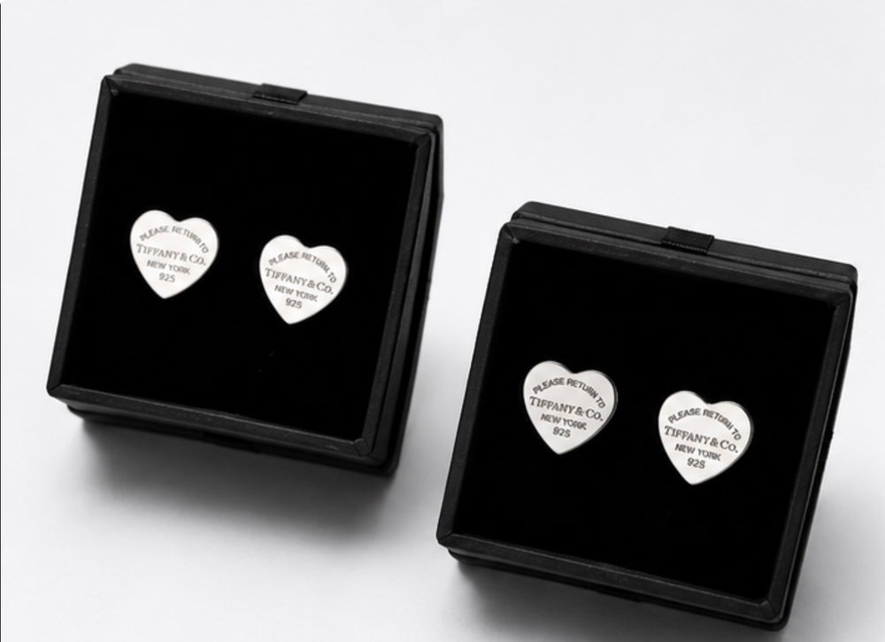 Silver heart-shaped stud earrings with engraved detail