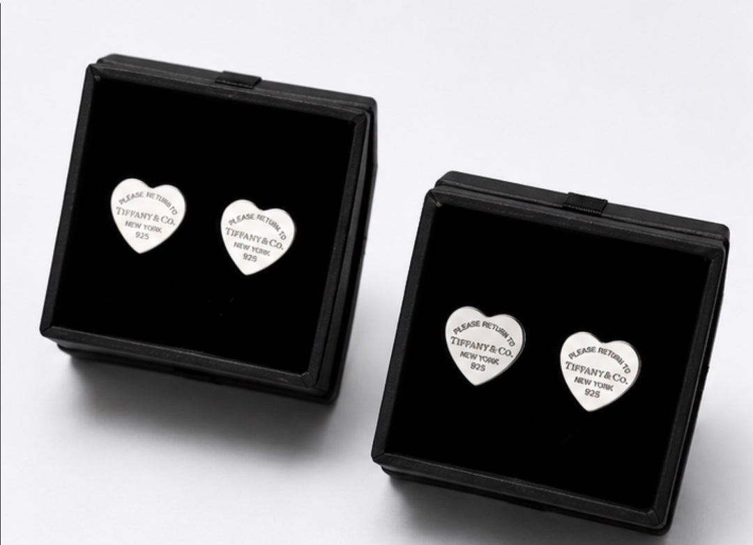 Silver heart-shaped stud earrings with engraved detail