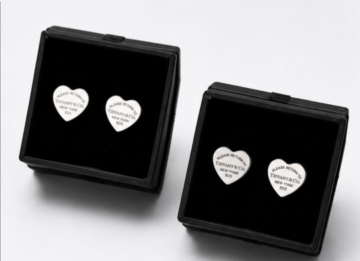 Silver heart-shaped stud earrings with engraved detail