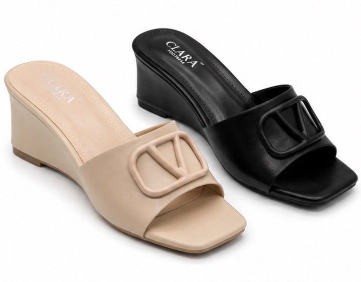 Black and nude wedge mule heels with oversized buckle detail