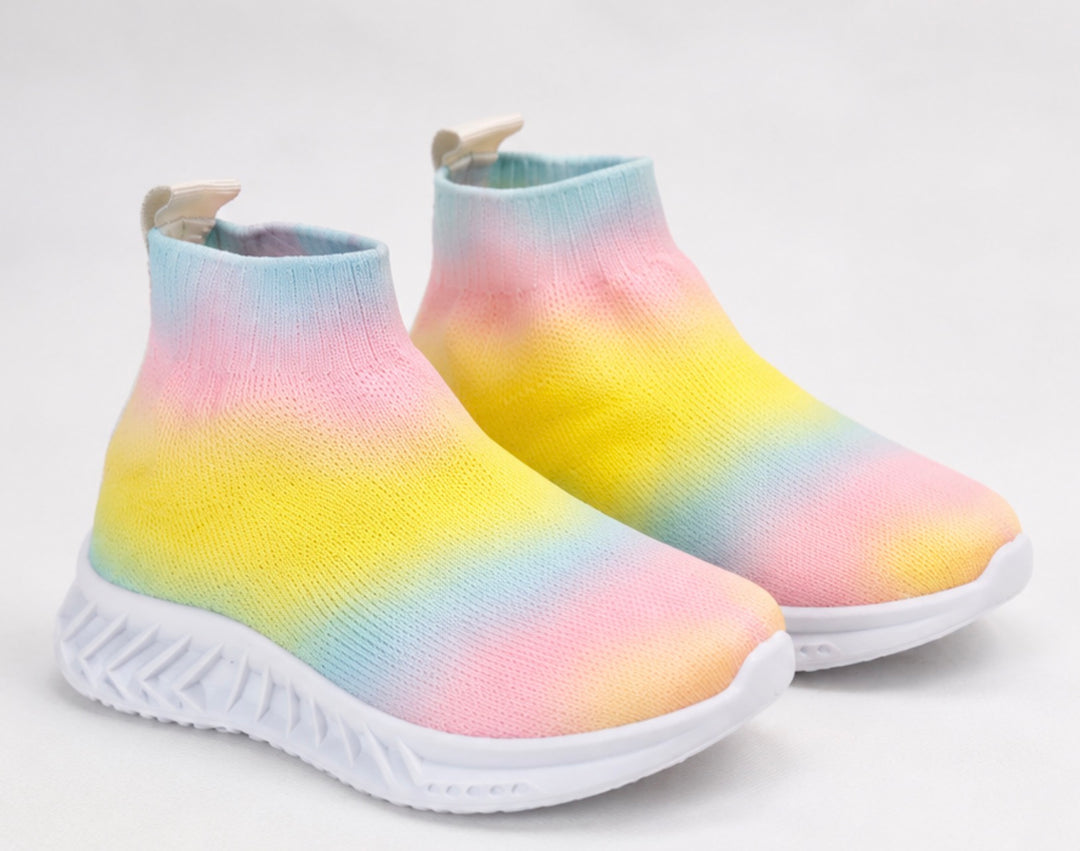 Children’s rainbow slip-on trainers with soft sock-style fit and chunky white grip sole