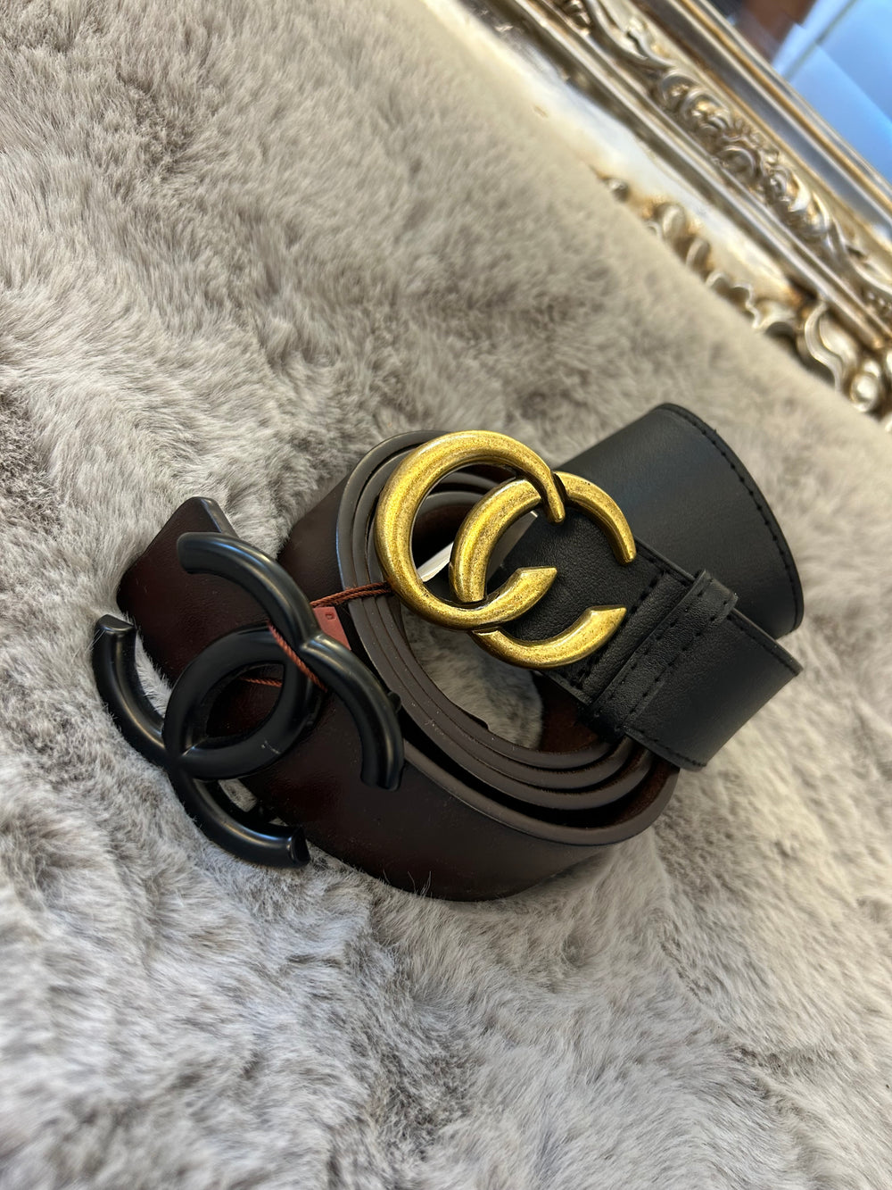 A belt with a gold-coloured buckle faux leather material