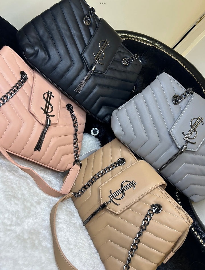 A collection of quilted medium sized handbags with chain detail in black, grey, pink, and beige colours.