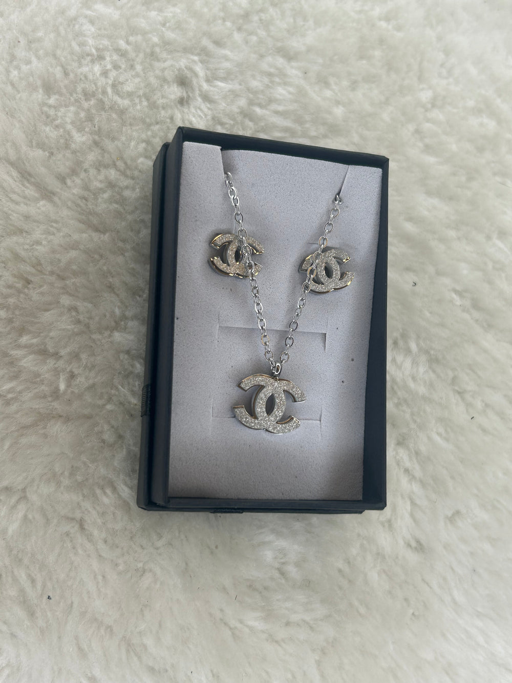 Silver matching necklace and earrings with sparkling crystal detailing
